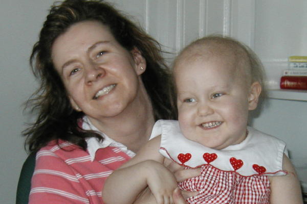 Smiling with mama, nearly all her hair is gone.
